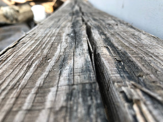 Photos surface of the wood in gray tones with a blurred background.