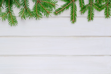 Christmas background, green fir branches, white boards