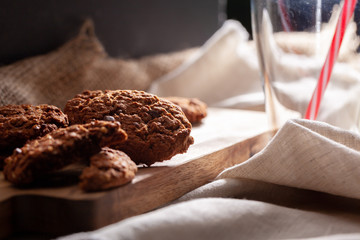 Chocolate crispy cookies with glass of milk close up