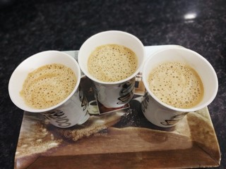 cup of coffee with whipped cream on wooden background