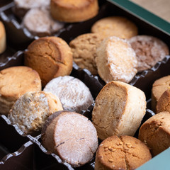 Variety of Spanish shortbreads Mantecados, polvorones, nevaditos in black box. Typical sweets consumed at Christmas time in Spain.