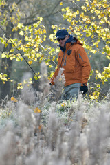 fly fisherman in the wild in autumn