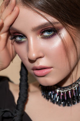 Obraz premium Young attractive model with the professional colorfull make-up, bright color eyeshadows and original braid hairstyle.