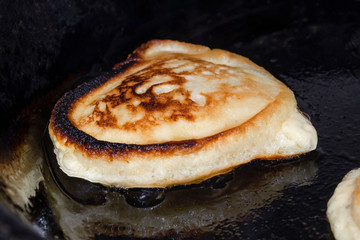 Cooking pancakes on the hot frying pan