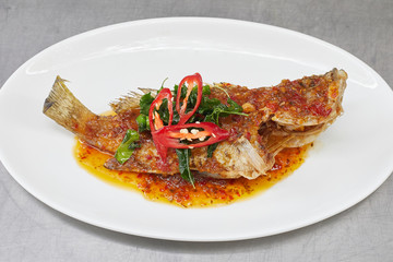 Fried fish toppted with chilli sauce, Thai cuisine .