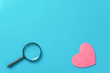 heart and magnifying glass on blue background, mock up, space for text