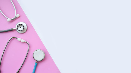 close up of stethoscope on white and pink background     