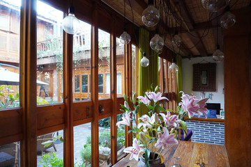 Beautiful pink blossom lilies inside the wooden living room.