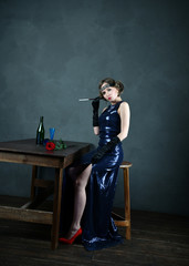 girl in evening blue dress with a cigarette