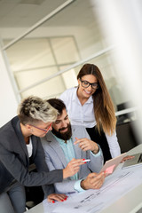 Obraz premium Group of coworkers working together on business project in modern office