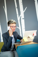 Portrait of successful businesswoman working with laptop