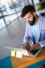 Young employee working on computer during working day in office