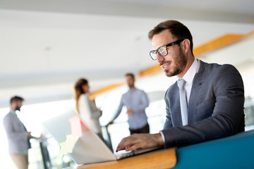 Portrait of young man sitting at desk in the office