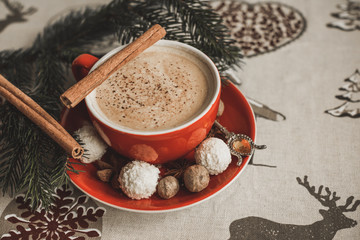 Cozy Christmas cup of coffee, magic evening at home. Scene of holidays detail