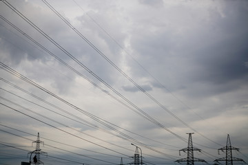power transmission line in the city with cloudy sky