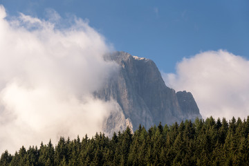 Mountain peak in the morning mist with long exposure of clouds, natural landscapes in Dolomites, Italy