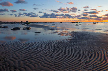 Beach sunset is  golden sky with  wave rolling to shore