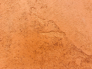 orange color painting on rough and ruined cement wall in full frame shot, using for background