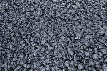 Embossed texture of the new pavement. Coarse asphalt.