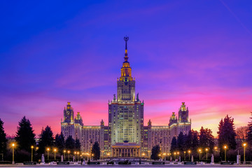 Purple sunset sky over the majestic building of the Stalin era in Moscow. The blue hour after sunset. Beautiful city lighting.