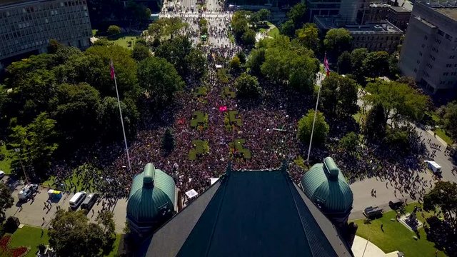 Climate strike protest crowd gathers at Legislature building, aerial