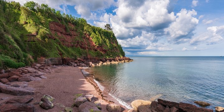 Clouds over the beach in Maidencombe, Torbay, England, UK