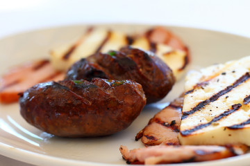 Meze meat dish on a plate, cutlet, cheese, grilled chicken.