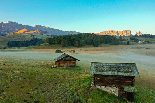 Aerial view of the valley in the fog during dawn in the Alpe di Suisi region. Dolomites in Italy in the fall