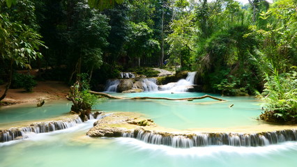 A beautiful rock formation with a small lake within the Kuang Si Falls in Luang Prabang, Laos