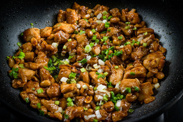 Homemade Kung Pao Chicken with Peanuts, Peppers, Soy Sauce, Green Chives and Veggies in Wok Pan
