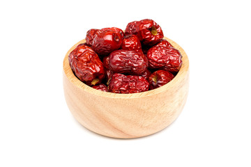 Bright red Chinese jujube in wood bowl on white background with clipping path.