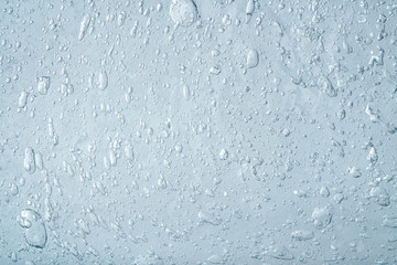 Abstract blue liquid background. Texture of thick transparent gel with a lot of bubbles. Cosmetics product.