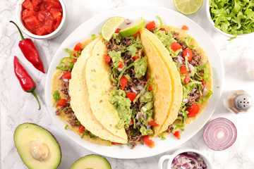 tacos with beef, avocado and tomato