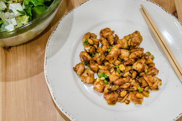 Homemade Kung Pao Chicken with Peanuts, Peppers, Soy Sauce, Green Chives and Veggies.