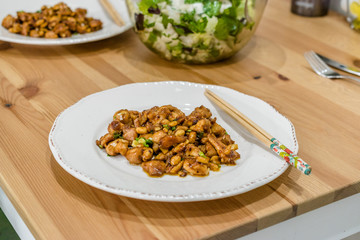 Homemade Kung Pao Chicken with Peanuts, Peppers, Soy Sauce, Green Chives and Veggies.
