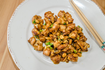 Homemade Kung Pao Chicken with Peanuts, Peppers, Soy Sauce, Green Chives and Veggies.