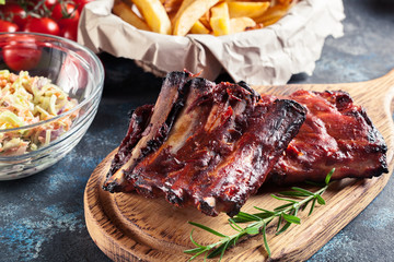 Spicy barbecued pork ribs served with BBQ sauce