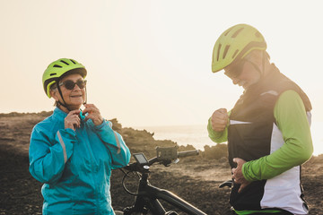 couple of two seniors or mature persons giving five with their hands together - friendship of two pensioner doing exercise together