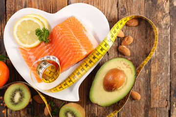 health food- salmon, avocado, almond and kiwi with meter slim concept