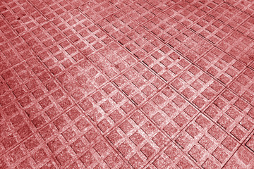 Fototapeta premium Stone pavement texture with blur effect in red tone.