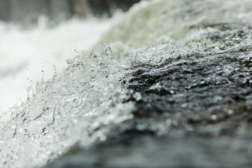 Bubbling water in a waterfall, splashes. Close-up. Abstract picture. North of Russia.