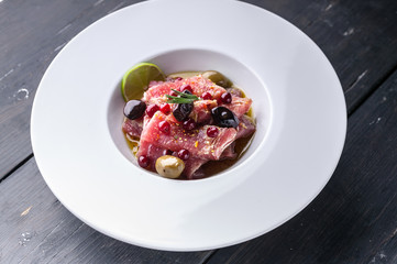 Italian recipe for tuna carpaccio with olive oil, spices and lime juice. Food porn. Mediterranean Kitchen. Ketogenic diet meals