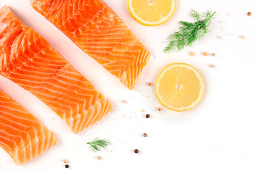 Salmon with lemon and dill, top shot with salt and pepper on a white background with a place for...