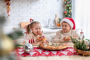 kids eat pizza in the kitchen
