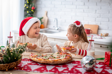 kids eat pizza in the kitchen