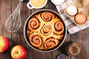 cinnamon brioche, cinnamon roll on wood background