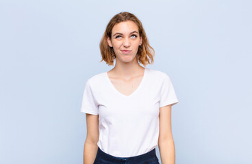 young blonde woman looking goofy and funny with a silly cross-eyed expression, joking and fooling...