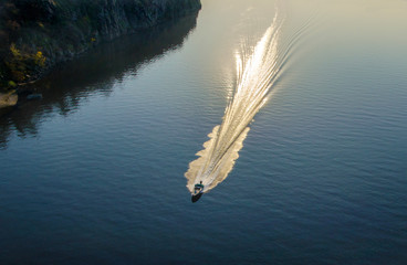 motor boat rushing on the blue surface of the water