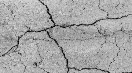 Cracked concrete texture closeup. Abstract cement background. Old concrete cement with cracks and natural destruction from time and weather conditions.