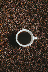 Naklejka premium Cup of coffee with cofee beans